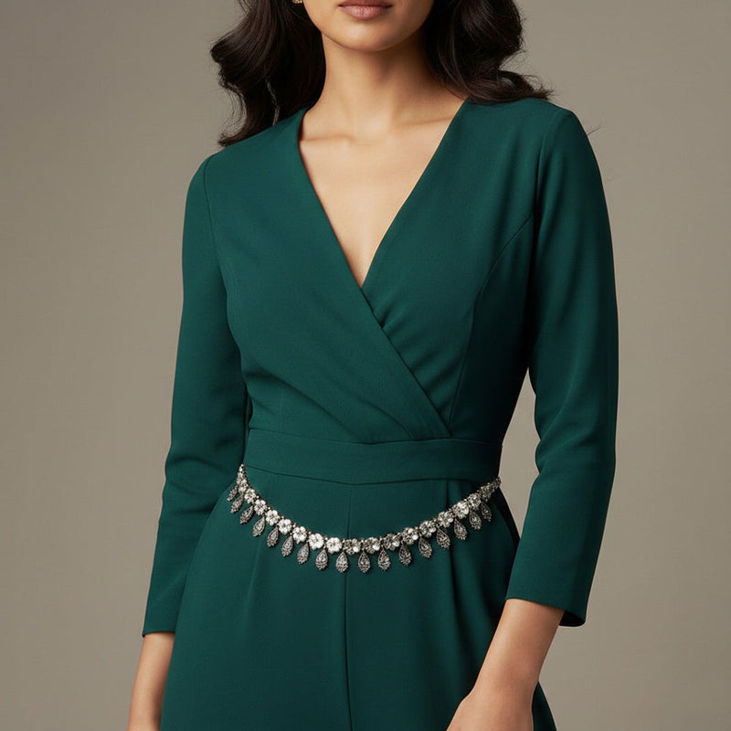 Layered silver chain necklace with coin charms and red and beige bead accents