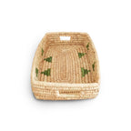 Woven basket with green patterns on a white background