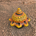Decorative object with intricate design on a textured brown surface