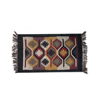 Decorative rug with geometric pattern and fringes on a white background