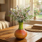 Decorative vase with a bouquet of flowers on a wooden table