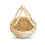 Woven basket with handles on a white background