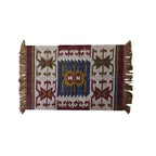 Decorative rug with geometric pattern and fringes on a white background