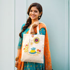 Woman holding a tote bag with decorative design against a light blue background