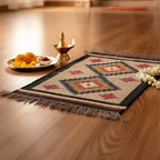 Decorative mat with floral arrangement and lamp on wooden floor