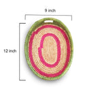 Woven basket with pink and beige pattern and green rim, showing dimensions on a white background.