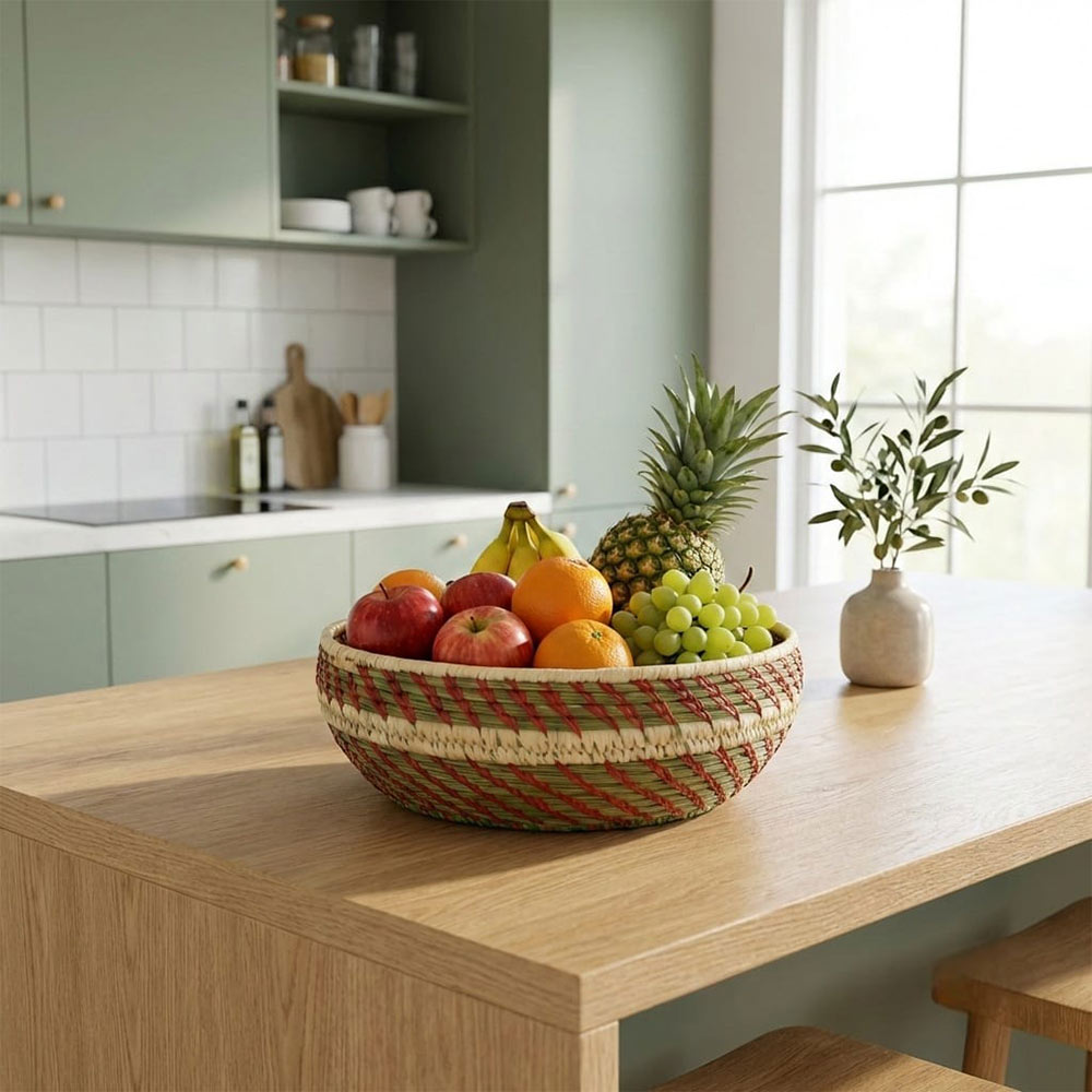 Fruit bowl on a kitchen counter with a view of a kitchen.
