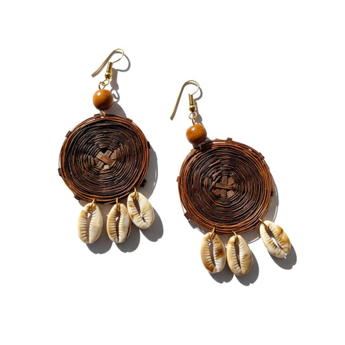 Pair of earrings with brown circular design and shell-like elements on a white background
