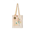 Beige canvas tote bag with embroidered brick window, flowers, and hanging ornament detail