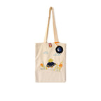 Beige canvas tote bag with embroidered girl, flowers, clouds, and blue sun design
