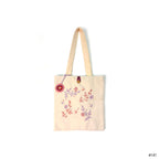 Cream canvas tote bag with pink and purple floral embroidery and a button closure