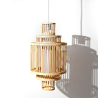 Wooden pendant lamp casting a shadow on a white wall