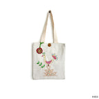 White canvas tote bag with colorful embroidered bird and geometric patterns, wooden button, and red flower charm