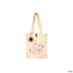 Beige canvas tote bag with pink and green floral embroidery and button closure