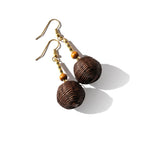 Pair of brown spherical earrings with gold hooks on a white background