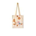 Beige canvas tote bag with embroidered pink bird on branch and crochet pendant