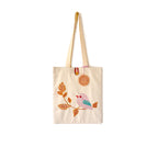 Beige canvas tote bag with embroidered pink bird on branch and crochet pendant
