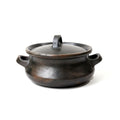 Black ceramic pot with lid on a white background