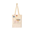Beige canvas tote bag with colorful embroidered bicycle and flowers design, blue crocheted tag