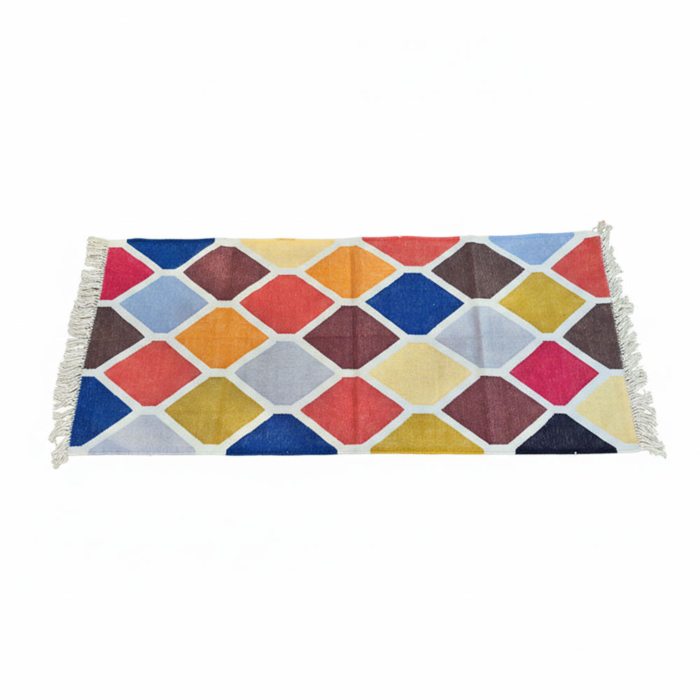 Colorful geometric patterned rug with tassels on a white background