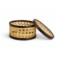 Woven basket with wooden lid on a white background
