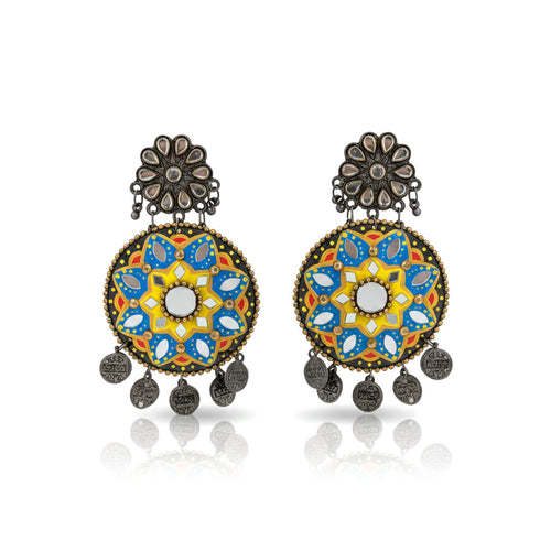 Pair of decorative earrings with floral design on a white background