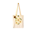 Beige canvas tote bag with embroidered yellow flowers and green leaves, featuring a button closure and a decorative round charm
