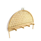 Woven rattan wall hook with geometric pattern on a white background