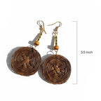 Brown spiral earrings with gold accents on a white background