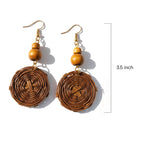 Wooden earrings with circular designs and wooden beads on a white background