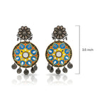 Pair of colorful earrings with floral design and measurement label on a white background
