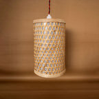 Woven rattan pendant light on a brown background