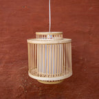 Beige woven pendant light against a red-brown textured wall