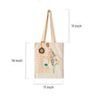 Beige cotton tote bag with floral embroidery and brick wall design, 11x14 inches, long handles