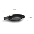 Black ceramic dish with measurements on a white background