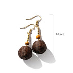 Brown spherical earrings with gold accents on a white background