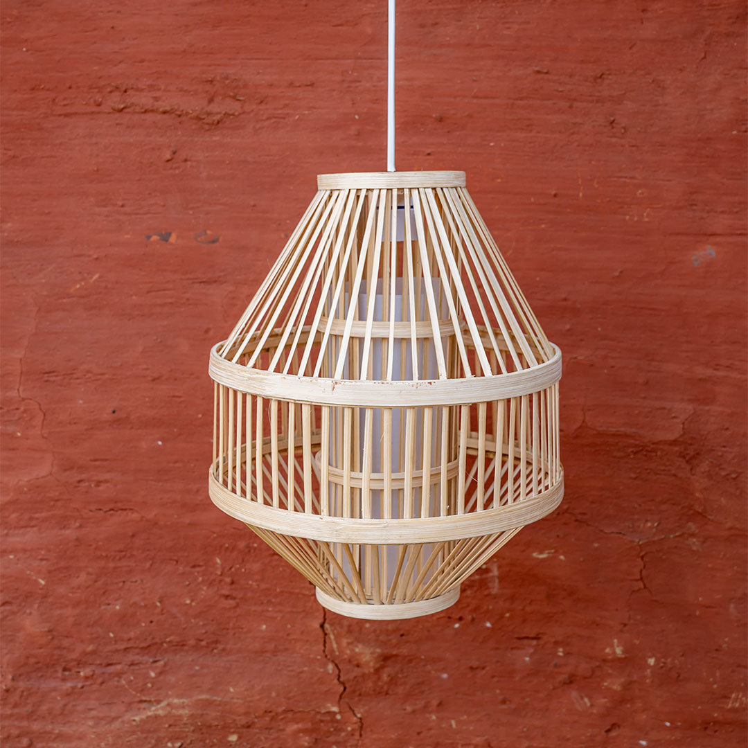 Woven pendant light against a red brick wall