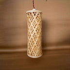 Woven bamboo lamp on a brown background