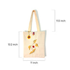 Beige tote bag with floral embroidery and measurements on a white background
