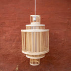 Wooden pendant lamp against a red brick wall