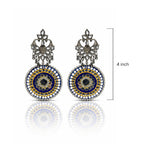 Pair of ornate earrings with blue and gold design on a white background