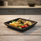 Platter of cheese, olives, and bread on a wooden table