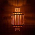 Woven lampshade casting a warm glow against a dark background