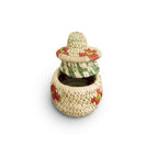 Stack of woven baskets with floral patterns on a white background