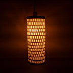 Cylindrical lamp with a geometric pattern on a dark background