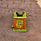 Decorative box with a swastika design on a textured wall background