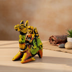 Decorative figurine of a camel with riders on a wooden surface