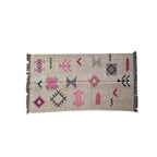 Woven rug with geometric patterns on a beige background