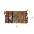 Woven rug with geometric pattern and tassels, shown with dimensions on a white background
