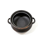 Black cast iron pot on a white background